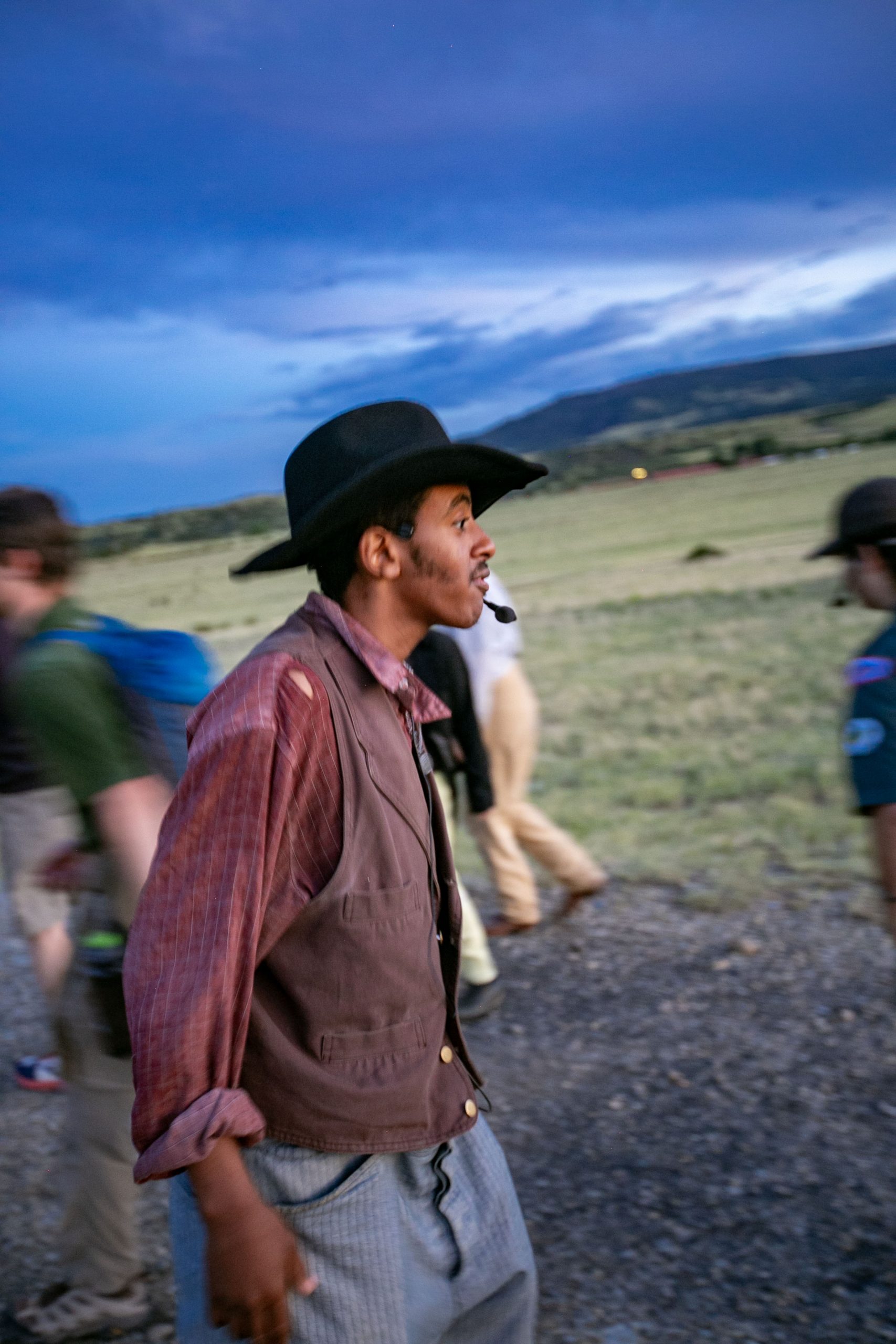 A staff member greets scouts as they enter the opening campfire